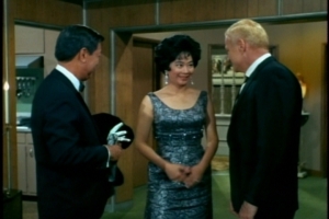 Mrs. Chang mentions that her father-in-law has been feeling ill, but Mr. Chang thinks company will do him good. (Again, I just love that gown.)